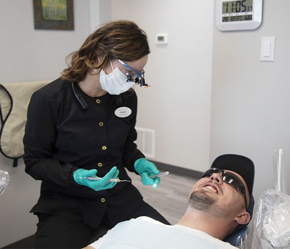 Dental team member talking to patient during treatment visit