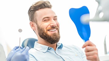 Man smiling at his dental implants in Longmont