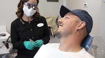 Implant dentist in Longmont speaking to a patient