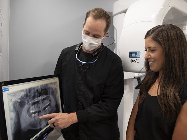 Dentist and patient reviewing x-rays during restorative dentistry