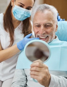 a person holding their cheek due to tooth pain